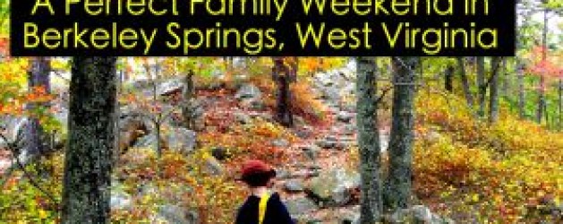 A person wearing a red hat hikes on a rocky trail through a forest with colorful autumn foliage. The text at the top reads, "A Perfect Family Weekend in Berkeley Springs, West Virginia.