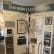 A display board titled "Trustees of The Berkeley Springs" showcases a collection of historical documents, framed photographs, and artifacts, including a gavel and a walking cane. The board is situated in a well-lit room.