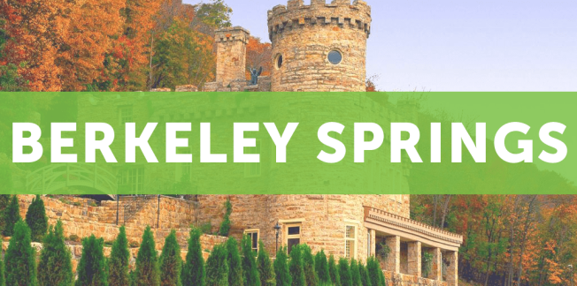 A stone castle-like building surrounded by autumn trees, with the words “BERKELEY SPRINGS” in bold white letters over a green transparent banner.